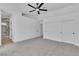 This main bedroom has neutral walls, carpet flooring, a ceiling fan, and an ensuite bathroom at 3109 Siena Cir, Las Vegas, NV 89128