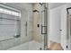 This shower has tile walls, shelves, and a black shower head with a glass door at 3109 Siena Cir, Las Vegas, NV 89128