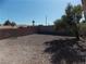 Large, gravel-filled backyard with brick perimeter wall, offering privacy and low maintenance at 319 Mulberry Glen Dr, North Las Vegas, NV 89031