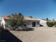 Spacious backyard with desert landscaping, mature trees, and a patio at 319 Mulberry Glen Dr, North Las Vegas, NV 89031
