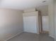 Bedroom with neutral carpet, closet with sliding doors, and access to another room at 319 Mulberry Glen Dr, North Las Vegas, NV 89031