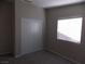 Cozy bedroom featuring a double door closet and bright window at 319 Mulberry Glen Dr, North Las Vegas, NV 89031