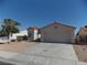 Charming single-story home featuring a tile roof, two-car garage, and low maintenance landscaping at 319 Mulberry Glen Dr, North Las Vegas, NV 89031
