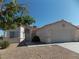 Attractive single-story home with a tile roof, arched entryway, two-car garage, and minimal landscaping at 319 Mulberry Glen Dr, North Las Vegas, NV 89031
