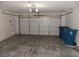 Spacious two-car garage with white doors and concrete floor, ideal for parking and storage at 319 Mulberry Glen Dr, North Las Vegas, NV 89031
