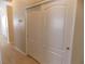 Neutral hallway featuring stylish closet with white doors and gold hardware, and neutral paint at 319 Mulberry Glen Dr, North Las Vegas, NV 89031