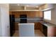 Kitchen featuring ample wood cabinets, tile floors, granite countertops and black appliances at 319 Mulberry Glen Dr, North Las Vegas, NV 89031