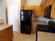 Kitchen with wood cabinets, granite countertops, and black appliances including gas range at 319 Mulberry Glen Dr, North Las Vegas, NV 89031