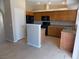 Open concept kitchen featuring tile floors, wood cabinets, and modern appliances at 319 Mulberry Glen Dr, North Las Vegas, NV 89031