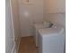 Small laundry room featuring washer and dryer, tile floor and access to the backyard at 319 Mulberry Glen Dr, North Las Vegas, NV 89031