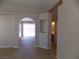 Open living space with neutral paint, tile floors, and arched doorway to another room at 319 Mulberry Glen Dr, North Las Vegas, NV 89031