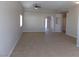 Bright living room with high ceilings, neutral paint, tile floors, and a ceiling fan at 319 Mulberry Glen Dr, North Las Vegas, NV 89031
