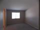 Neutral living room featuring neutral paint, neutral carpet, and a large window at 319 Mulberry Glen Dr, North Las Vegas, NV 89031