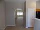 View of the living room and kitchen with tile floors and neutral paint at 319 Mulberry Glen Dr, North Las Vegas, NV 89031
