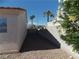 Narrow side yard with desert landscaping and block wall, offering privacy at 319 Mulberry Glen Dr, North Las Vegas, NV 89031