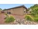 Landscaped backyard featuring desert plants, rocks, and gravel at 3805 Specula Wing Dr, North Las Vegas, NV 89084