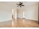 Large bedroom with backyard access, wood-style tile flooring, and modern ceiling fan at 3805 Specula Wing Dr, North Las Vegas, NV 89084