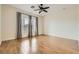 Bright bedroom featuring a ceiling fan, and wood-style tile flooring at 3805 Specula Wing Dr, North Las Vegas, NV 89084