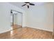 Bedroom with wood-style tile floors, mirrored closet doors, and a ceiling fan at 3805 Specula Wing Dr, North Las Vegas, NV 89084