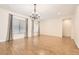 Spacious dining room with wood-look floors, a chandelier, and large windows at 3805 Specula Wing Dr, North Las Vegas, NV 89084