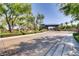 A gated community entrance with lush landscaping and decorative stone columns at 3805 Specula Wing Dr, North Las Vegas, NV 89084