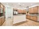 Spacious kitchen with wooden cabinets, stainless steel appliances, granite countertops, and island at 3805 Specula Wing Dr, North Las Vegas, NV 89084