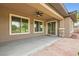 Covered patio with stone accents, a ceiling fan, and views of the backyard at 3805 Specula Wing Dr, North Las Vegas, NV 89084