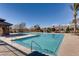 Enjoy this zero-entry pool with mountain views, umbrellas, and a beautiful stone clubhouse at 3805 Specula Wing Dr, North Las Vegas, NV 89084
