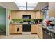 Kitchen features wood cabinets, black appliances and natural light at 3823 S Maryland Pkwy # P1, Las Vegas, NV 89119
