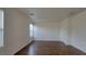 Well-lit bedroom with wood floors, window with blinds, and bright white walls at 386 Botanic Gardens Dr, Las Vegas, NV 89148