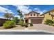 Charming two-story home featuring a well-manicured front yard with stone and desert landscaping at 386 Botanic Gardens Dr, Las Vegas, NV 89148