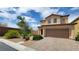 Two-story home with desert landscaping and a two car garage at 386 Botanic Gardens Dr, Las Vegas, NV 89148
