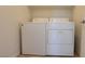 Well-lit laundry area showcases a white washer and dryer at 386 Botanic Gardens Dr, Las Vegas, NV 89148