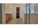 Bright bathroom featuring a vanity, large mirror, glass-enclosed shower, and adjacent walk-in closet at 386 Botanic Gardens Dr, Las Vegas, NV 89148