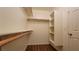 Walk-in closet with built-in shelving and wood-style flooring provides ample storage space at 386 Botanic Gardens Dr, Las Vegas, NV 89148
