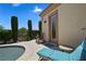 Backyard lounge area with lush landscaping, pool access, and a peaceful ambiance for relaxation and outdoor enjoyment at 4208 Agosta Luna Pl, Las Vegas, NV 89135