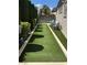 The turfed backyard has seating and space for outdoor activities at 4208 Agosta Luna Pl, Las Vegas, NV 89135
