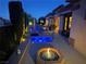 Relaxing backyard area with a spa, fire pit, and covered patio, perfect for entertaining at 4208 Agosta Luna Pl, Las Vegas, NV 89135