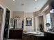 The bathroom boasts a large soaking tub with marble surround, complemented by dual sinks and etched mirrors at 4208 Agosta Luna Pl, Las Vegas, NV 89135