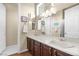 Bathroom with double sinks, dark wood cabinets, and a large vanity mirror at 4208 Agosta Luna Pl, Las Vegas, NV 89135