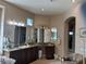 Bright bathroom vanity with framed etched glass mirrors and granite counters, offering a stylish space at 4208 Agosta Luna Pl, Las Vegas, NV 89135