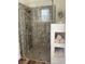 Modern bathroom with glass shower, tiled walls, and built-in storage at 4208 Agosta Luna Pl, Las Vegas, NV 89135