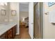 Well-lit bathroom showcasing vanity, shower, and a view into bedroom at 4208 Agosta Luna Pl, Las Vegas, NV 89135