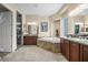 Bright bathroom with stone tub, dual vanity sinks, granite countertop and decorative shower at 4208 Agosta Luna Pl, Las Vegas, NV 89135