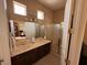 Bathroom featuring double sinks, vanity lighting, shower, and separate toilet at 4208 Agosta Luna Pl, Las Vegas, NV 89135