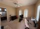 Spacious bedroom area featuring large windows, a ceiling fan, and versatile space for exercise or a home office at 4208 Agosta Luna Pl, Las Vegas, NV 89135