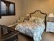 Comfortable bedroom with a floral comforter set, two bedside tables and lamps at 4208 Agosta Luna Pl, Las Vegas, NV 89135