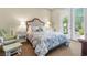 Inviting bedroom with comfortable bedding, French doors, and cozy armchair at 4208 Agosta Luna Pl, Las Vegas, NV 89135