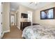 Inviting bedroom with bed, TV, a dresser, and a view to the hallway and en-suite bathroom at 4208 Agosta Luna Pl, Las Vegas, NV 89135
