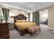 Spacious main bedroom with green curtains, natural light and neutral colored walls at 4208 Agosta Luna Pl, Las Vegas, NV 89135